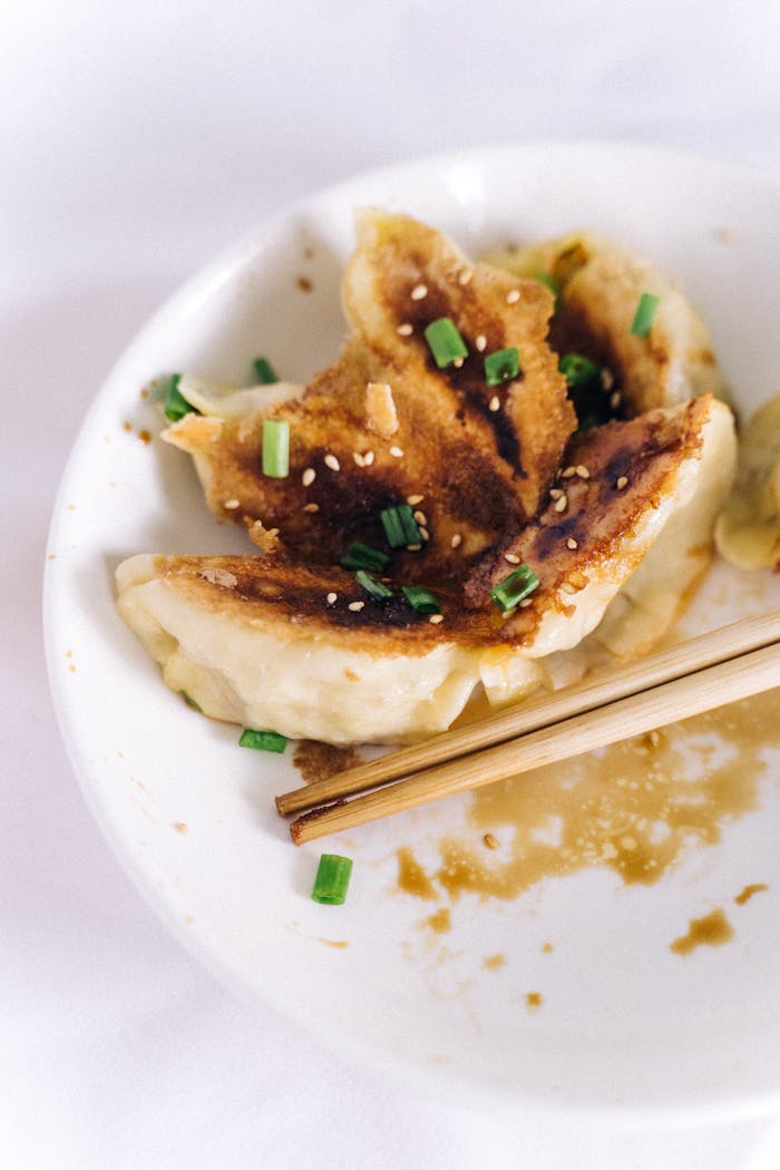 Delicious crispy dumplings with chives and sesame seeds, perfect for food enthusiasts.